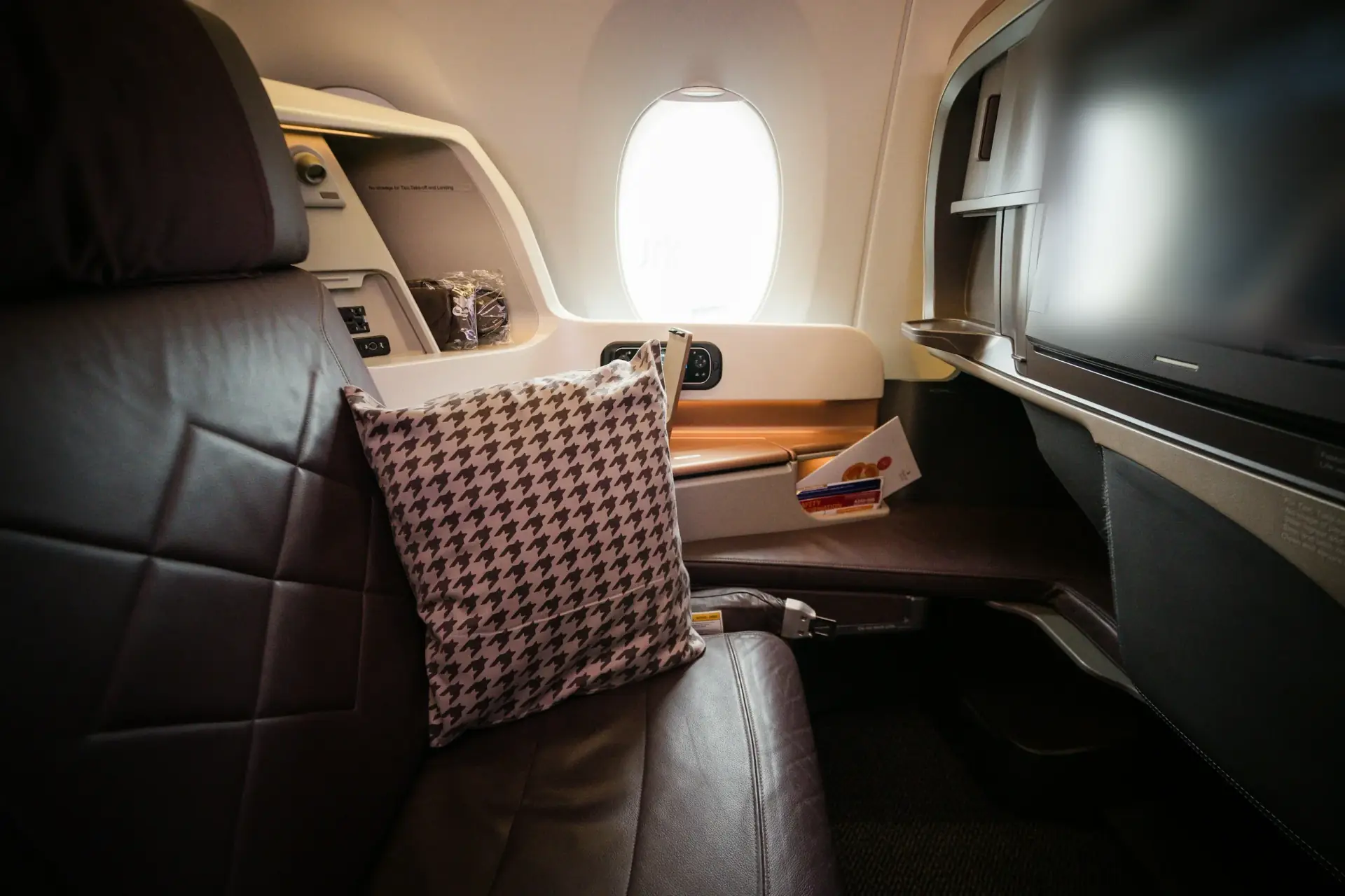 A business class suite lit by the window