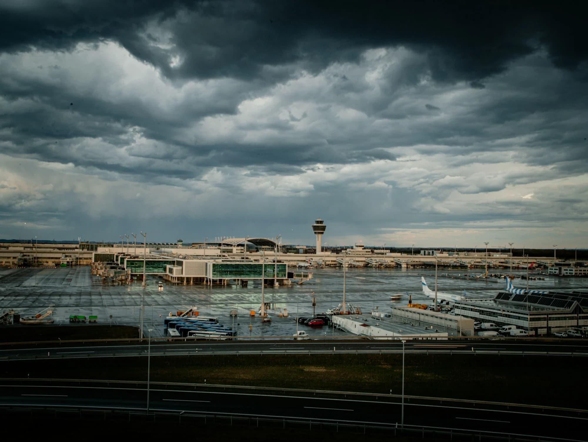 Storm clouds building over an airport terminal and apron