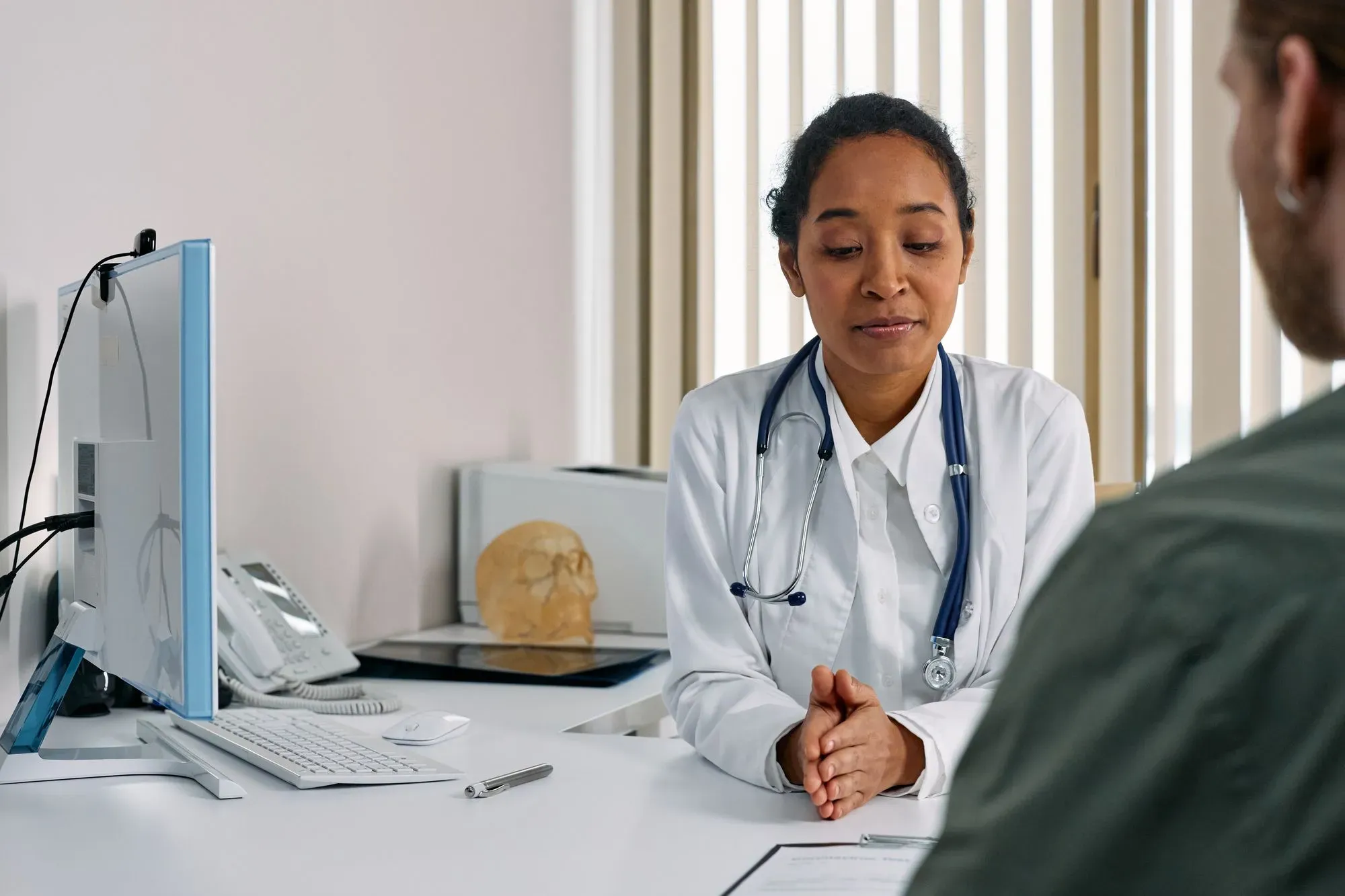 Doctor talking with a patient in a bright, modern clinic