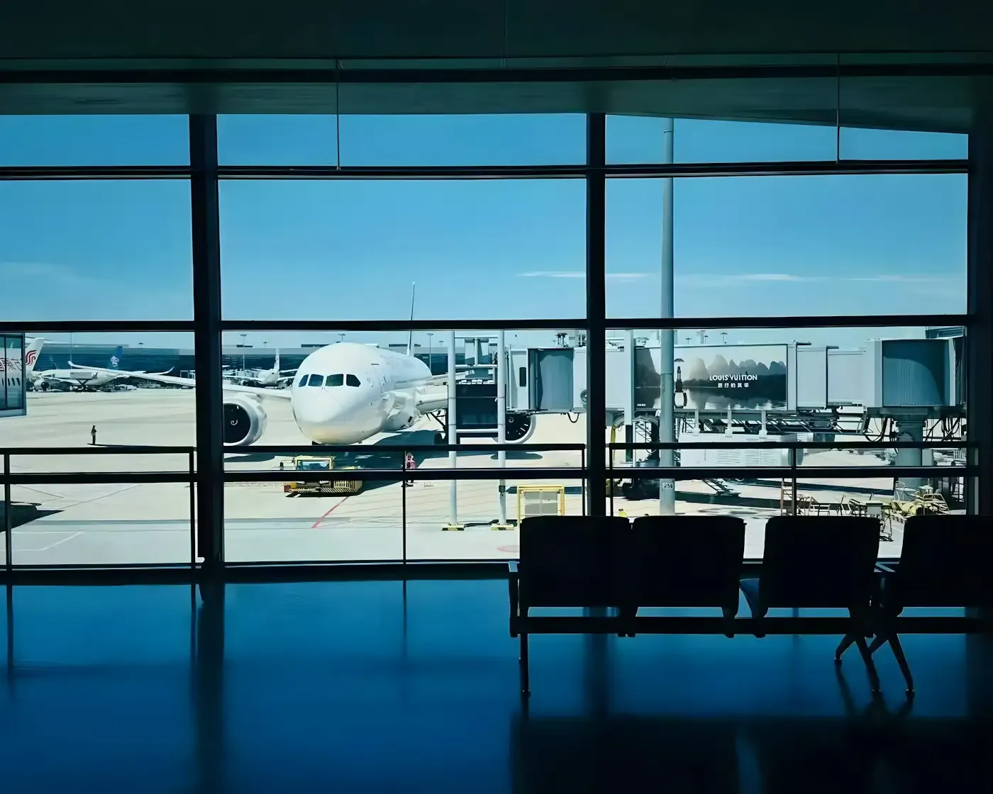 Aircraft at the gate seen through a terminal window